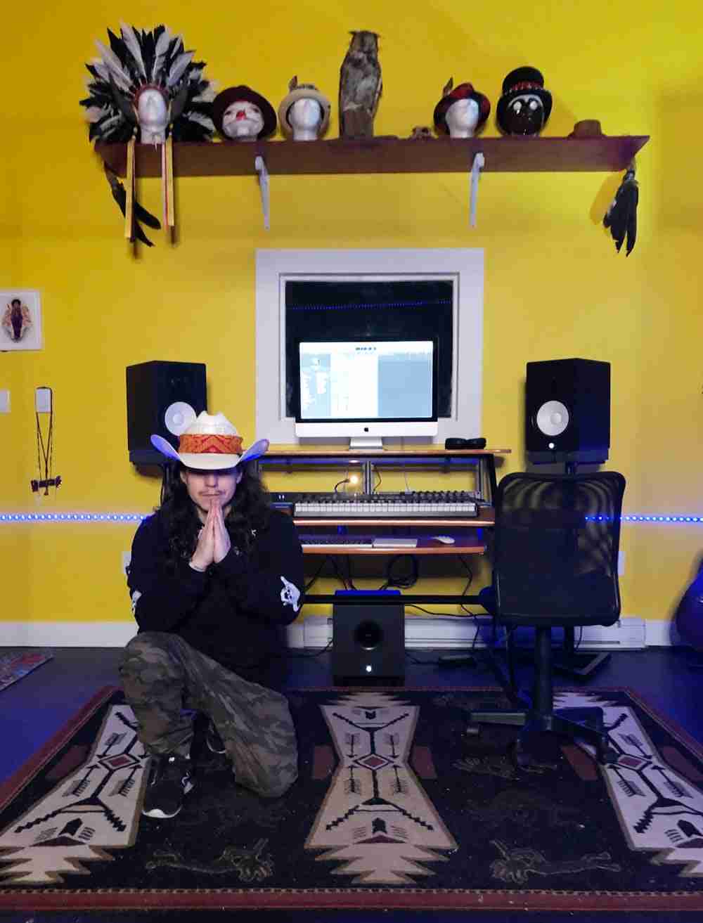 Joseph Laplante kneeling in his Ble$$ed Street Studios