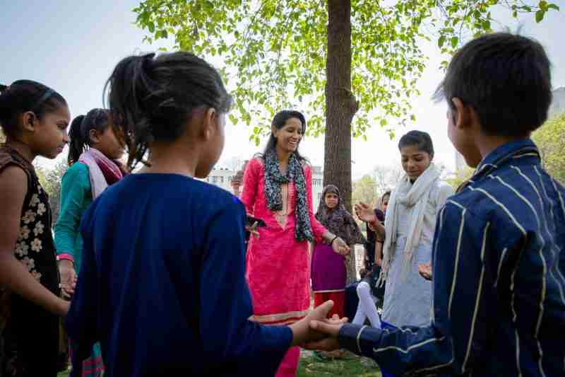 Khushboo, a Girl Icon in India, leads an educational game with kids from her community.